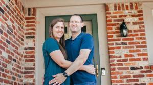 couple in front of home