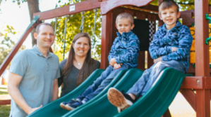 Family of four on a backyard playground