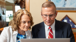 Two people looking at a computer.