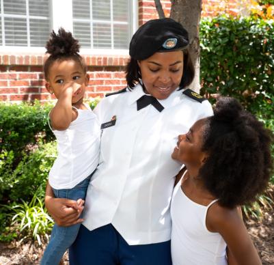 Uniformed mother with two young daughters