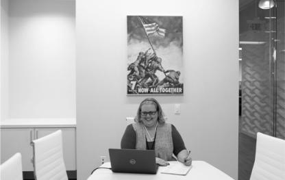 Woman with a laptop sitting at a table