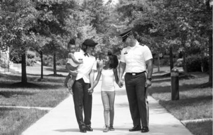 Man and woman walking with a child on a sidewalk