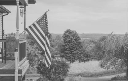 USA flag flying on the porch of a house