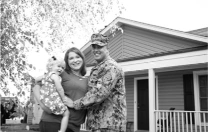 Couple standing in front of a house